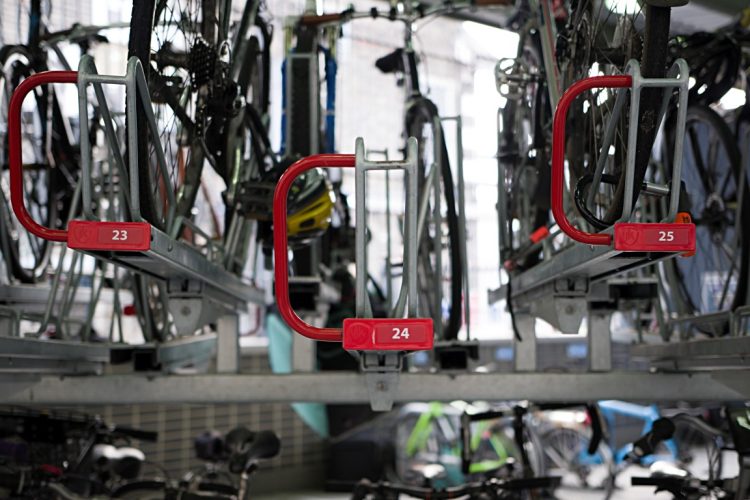 Red handles on Cyclehoop's Optima Two Tier Rack with ID numbers for accessibility when storing bike