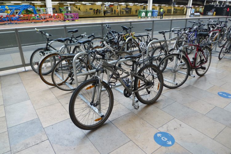 Cyclehoop toast rack installed in a train station with many bikes parked in the racks