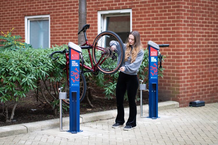 Cyclist using the Cyclehoop Deluxe Bike Repair Station to repair a bike while the bike is mounted