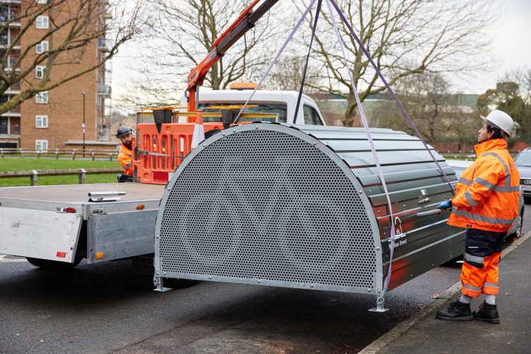 Installation of Cyclehoop Bike Hangar as it is unloaded by two workers from a truck with a built-in crane