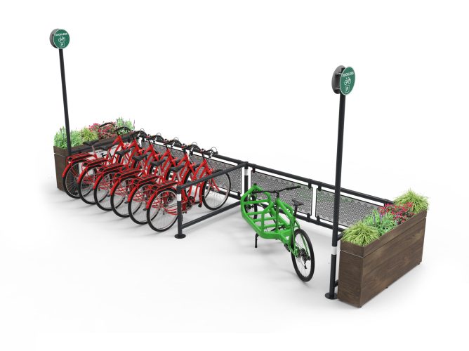 A side view of the Cyclehoop Mobility Corral, 6 red bikes are parked to the left with a green cargo bike parked on the right