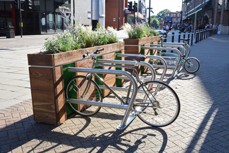 Side view of the Cyclehoop Planter Rack bike parking with two bikes parked