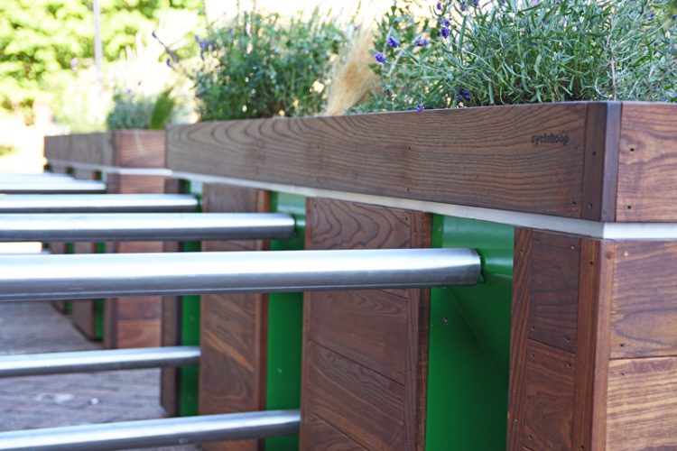 Close up view of the steel tube stands attaching to the wood planters, decorated with reflective strips