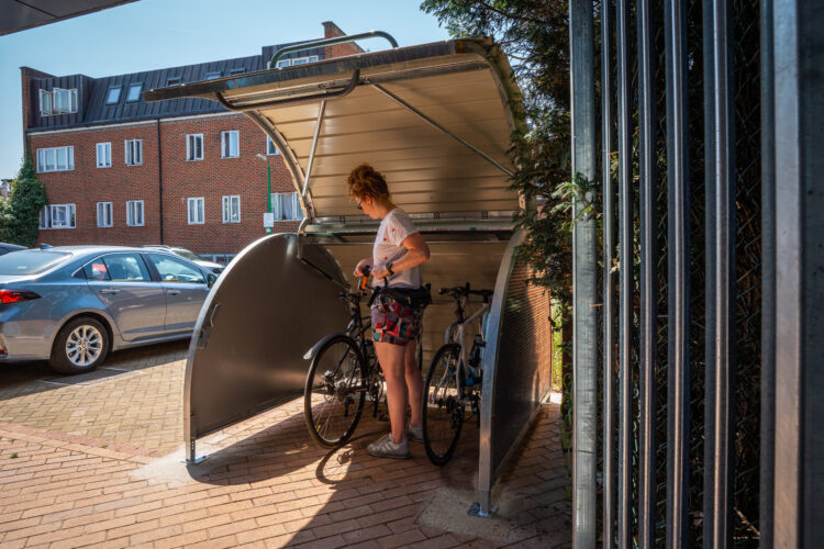 Woman locking bike in Mini Bikehangar