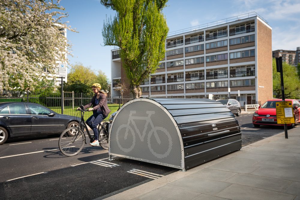 woman cycling past bikehangar